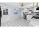 Bright kitchen with white cabinets, granite countertops, and stainless steel appliances at 691 Linden Dr, Englewood, FL 34223