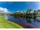 Scenic lake view with lush greenery and blue skies at 691 Linden Dr, Englewood, FL 34223