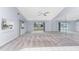 Spacious living area with vaulted ceiling, carpeting, and large window at 691 Linden Dr, Englewood, FL 34223