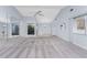 Spacious living room with mirrored wall, ceiling fan, and carpeted flooring at 691 Linden Dr, Englewood, FL 34223