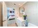 Bathroom with vanity, toilet, and view into bedroom at 8017 Bay Pointe Dr, Englewood, FL 34224