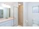 Clean bathroom with shower, single vanity, and tiled walls at 9 Bunker Ct, Rotonda West, FL 33947