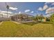 Large backyard with screened pool and lush lawn at 9266 Carnation Ave, Englewood, FL 34224