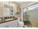Bathroom boasts granite vanity, a walk-in shower, and updated fixtures at 9266 Carnation Ave, Englewood, FL 34224