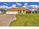 House exterior with driveway, landscaping, and garage at 9266 Carnation Ave, Englewood, FL 34224