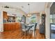 Bright kitchen with granite counters, wood cabinets, and breakfast nook at 9266 Carnation Ave, Englewood, FL 34224