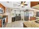 Kitchen features granite counters, wood cabinets, and a breakfast bar at 9266 Carnation Ave, Englewood, FL 34224