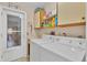 Laundry room with washer, dryer, cabinets, and exterior access at 9266 Carnation Ave, Englewood, FL 34224
