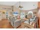 Open living space with hardwood floors, gray sofas and a large flat-screen TV at 9266 Carnation Ave, Englewood, FL 34224