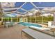 Screened pool area with lounge chairs and patio furniture at 9266 Carnation Ave, Englewood, FL 34224