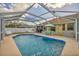 Screened pool with patio furniture, and a large covered patio at 9266 Carnation Ave, Englewood, FL 34224