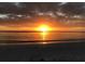 Stunning sunset over calm ocean waters at 9526 Jolly Roger Trl, Placida, FL 33946