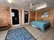 Simple bedroom with a double bed and wood paneling at 9526 Jolly Roger Trl, Placida, FL 33946