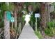 Private boardwalk through lush vegetation, leading to the beach at 9526 Jolly Roger Trl, Placida, FL 33946