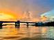 Scenic bridge view at sunset over a calm waterway, reflecting the sky's golden and orange colors at 9526 Jolly Roger Trl, Placida, FL 33946