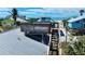Charming coastal home with a rooftop deck and stairs, surrounded by tropical vegetation near the ocean at 9526 Jolly Roger Trl, Placida, FL 33946