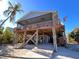 Elevated beach house with large deck, screened porch, and ramp access at 9526 Jolly Roger Trl, Placida, FL 33946