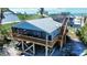 Inviting coastal home featuring a durable metal roof and a spacious elevated deck with ocean views at 9526 Jolly Roger Trl, Placida, FL 33946