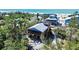 Beautiful coastal home featuring a rooftop deck near the beach, surrounded by tropical vegetation at 9526 Jolly Roger Trl, Placida, FL 33946
