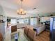 Open kitchen with stainless steel appliances and breakfast bar at 9526 Jolly Roger Trl, Placida, FL 33946