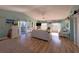 Spacious living room with vaulted ceiling, sliding glass doors, and casual coastal decor at 9526 Jolly Roger Trl, Placida, FL 33946