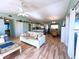 Open concept floor plan integrating living, dining, and kitchen areas with wood-look floors at 9526 Jolly Roger Trl, Placida, FL 33946