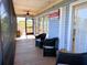 Screened porch with wicker furniture and access to the beach and water at 9526 Jolly Roger Trl, Placida, FL 33946