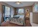 Cozy bedroom features a comfortable bed, ample natural light, and window coverings at 524 Pine Hollow Cir # 524, Englewood, FL 34223