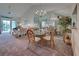 Bright dining area features a glass table and chairs, and access to the living room at 524 Pine Hollow Cir # 524, Englewood, FL 34223