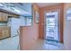 Bright entryway with kitchen view and access to balcony at 524 Pine Hollow Cir # 524, Englewood, FL 34223
