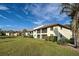 Condo building exterior with grassy lawn and pond view at 524 Pine Hollow Cir # 524, Englewood, FL 34223