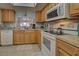 Bright kitchen features wood cabinets, updated appliances, and a pass-through to dining area at 524 Pine Hollow Cir # 524, Englewood, FL 34223