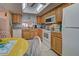 Charming kitchen boasts wood cabinets, modern appliances, and a breakfast nook at 524 Pine Hollow Cir # 524, Englewood, FL 34223