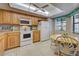 Well-equipped kitchen with wood cabinets and breakfast nook at 524 Pine Hollow Cir # 524, Englewood, FL 34223