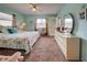 Bright main bedroom with king bed and access to a private balcony at 524 Pine Hollow Cir # 524, Englewood, FL 34223
