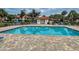 Community pool with plenty of lounge chairs at 524 Pine Hollow Cir # 524, Englewood, FL 34223