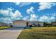 House exterior with large yard and driveway at 12473 Gallagher Blvd, Port Charlotte, FL 33981