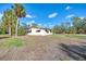 Ranch-style home with palm trees in front at 1460 Duncan Pl, Englewood, FL 34223