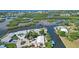 Aerial view of waterfront home with private dock and lush landscaping at 1493 Janet Pl, Englewood, FL 34223