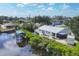 Aerial view of the property showcasing waterfront access, and lush greenery at 1493 Janet Pl, Englewood, FL 34223