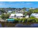 Aerial view shows home with waterfront, boat dock and the surrounding neighborhood at 1493 Janet Pl, Englewood, FL 34223