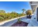 Landscaped backyard with walkway leading to canal at 1493 Janet Pl, Englewood, FL 34223