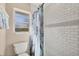 Bathroom with shower/tub combo, tile surround, and window at 1493 Janet Pl, Englewood, FL 34223