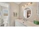 Well-lit bathroom featuring a modern vanity, sink, and mirror, with a view into the closet at 1493 Janet Pl, Englewood, FL 34223