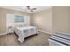 Cozy bedroom featuring a decorative headboard, neutral walls, and tiled floors for a comfortable retreat at 1493 Janet Pl, Englewood, FL 34223