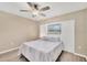 Bedroom with a queen bed, ceiling fan, and window at 1493 Janet Pl, Englewood, FL 34223