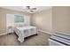 Bedroom with a queen bed, ceiling fan, and window at 1493 Janet Pl, Englewood, FL 34223