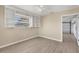 Bedroom with a ceiling fan, tiled floor, and built-in shelving with door leading to garage at 1493 Janet Pl, Englewood, FL 34223