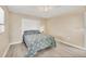 Second bedroom with a queen bed, neutral decor, and ceiling fan at 1493 Janet Pl, Englewood, FL 34223