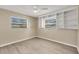 Bright bedroom with a ceiling fan, tiled floor, and built-in shelving for storage at 1493 Janet Pl, Englewood, FL 34223